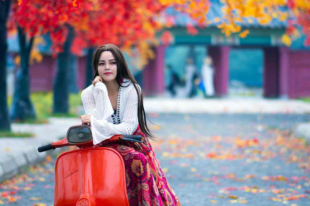 Vietnamese girl on red motorbike