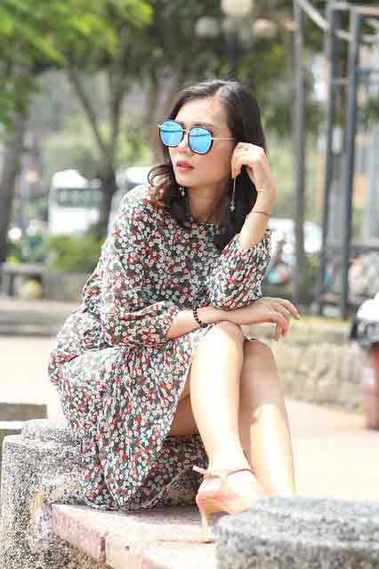 She ain't going to wait around forever: girl sitting down while wearing sunglasses